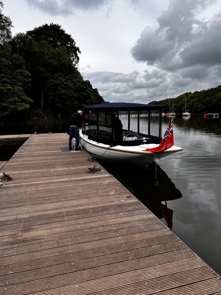 Two Walk residents cleaning a boat at Rudyard Lake